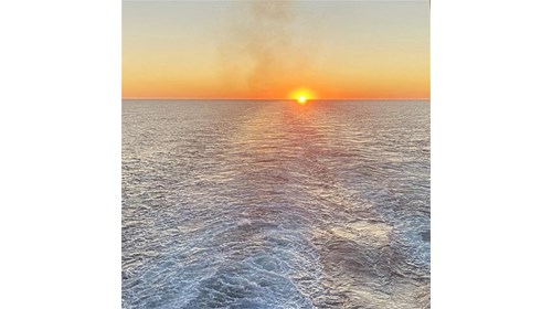 Sunset and the wake of Scarlet Lady