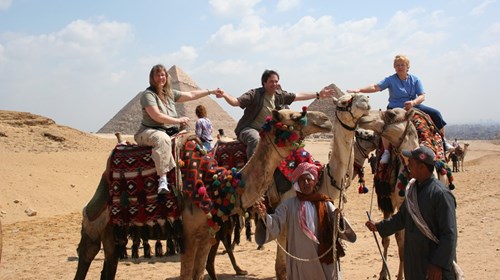 Riding Camels near the Egyptian Pyramids.