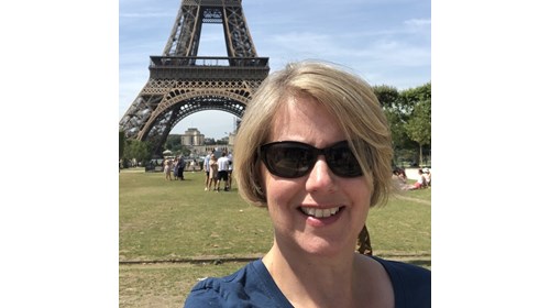 Mary at the Eiffel Tower on a scorching hot day.