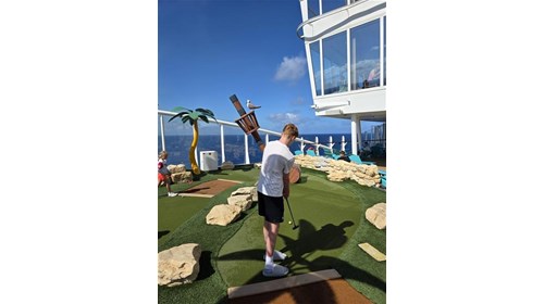 My son on Symphony of the Seas playing mini golf.