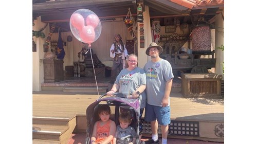 My husband and I with our grand kids at Disney