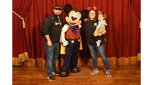 Kyle and part of her family meeting Mickey Mouse