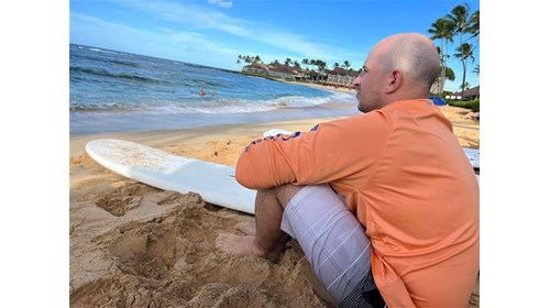 My husband's first surfing lessons on Poipu Beach