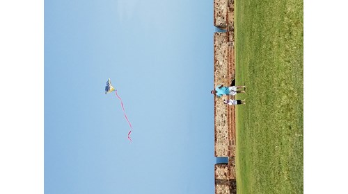 My husband and son flying a kite at El Morro.