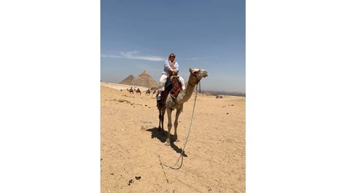 Kathy on a camel at the Pyramids of Egypt