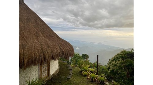 thatch-roof hut on mountain overlooking Colombia