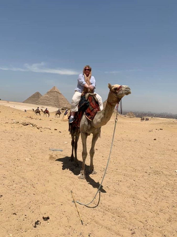 Kathy on a camel at the pyramids