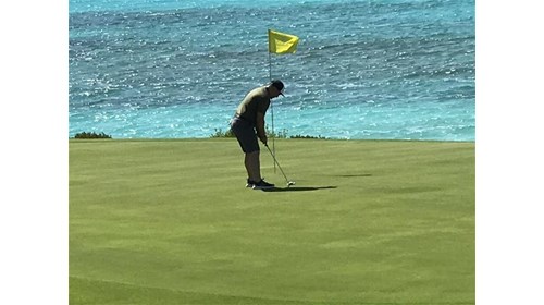 Golfer playing course at Sandals Exuma