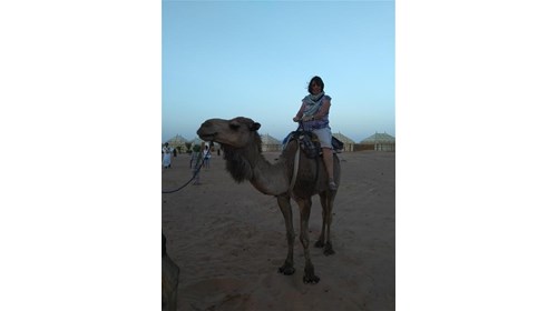 Riding a camel in the desert 
